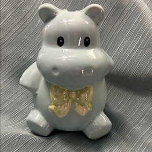 Ceramic Hippo Bank.  Light blue with green bow.